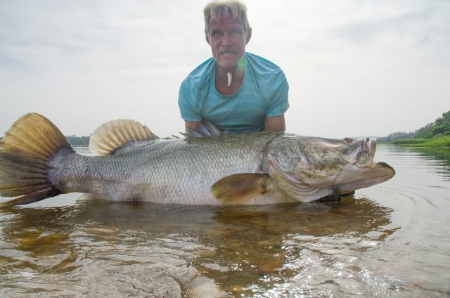 Nile River, Uganda - Fisherman and conservationist Andy Coetzee holding a Nile perch. (Earth Touch LTD)